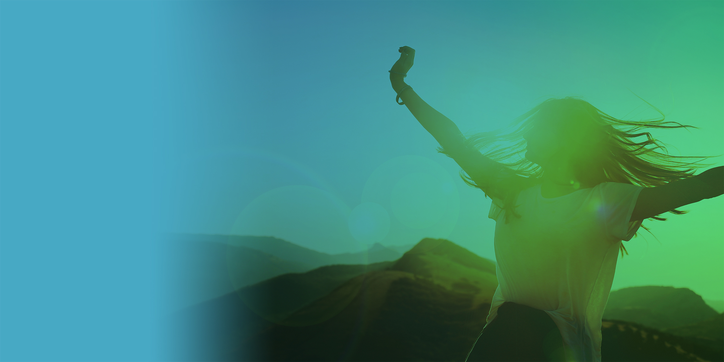 Girl on a background of mountains joyful spread her arms dancing